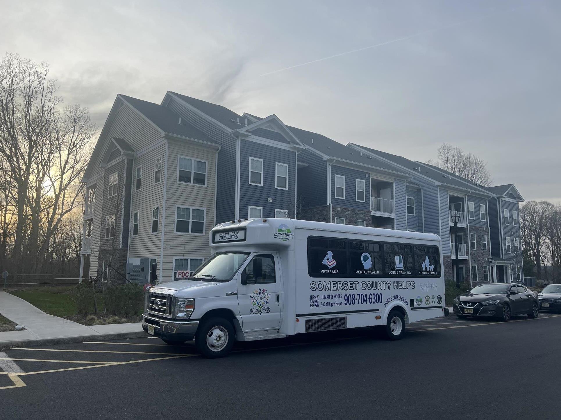 Somerset Helps Van in front of apartment complex