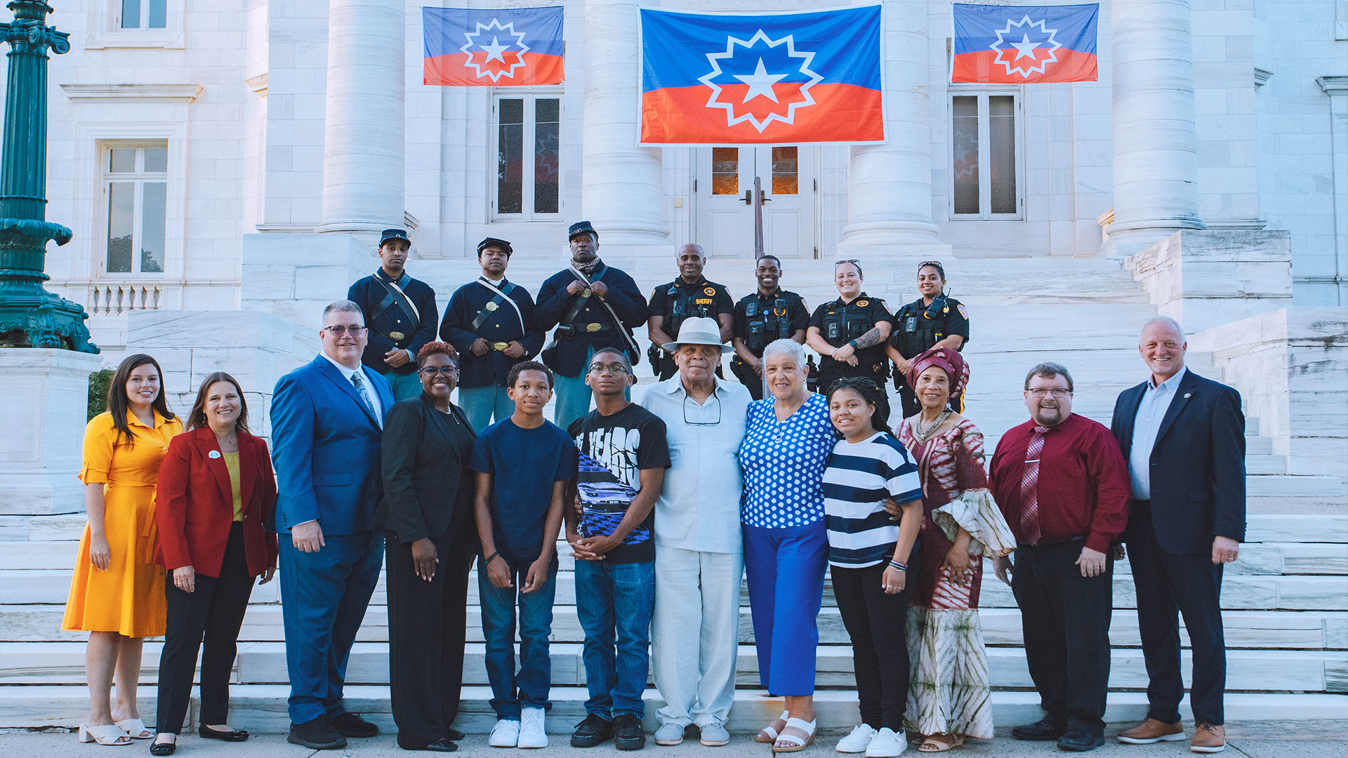 USCT reenactors pose with members of the police department, government officials, and the family of Juneteenth Leadership Award winner, Arthur E.D. Adair (bottom middle).